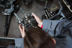 female mechanic holding spare parts